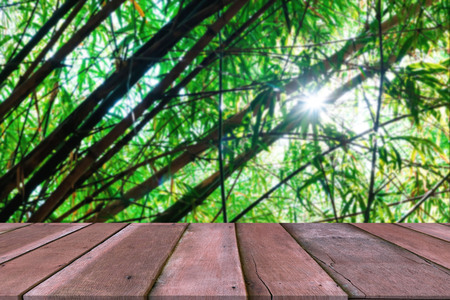 Wooden table with bamboo forest blurred backgroundの写真素材