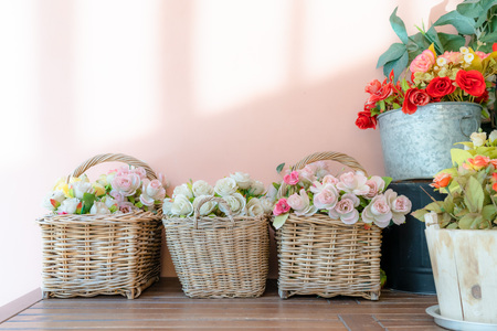 colorful rose flowers in wicker with pink wall backgrounds