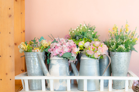 colorful rose flowers in pot with pink wall backgroundsの写真素材