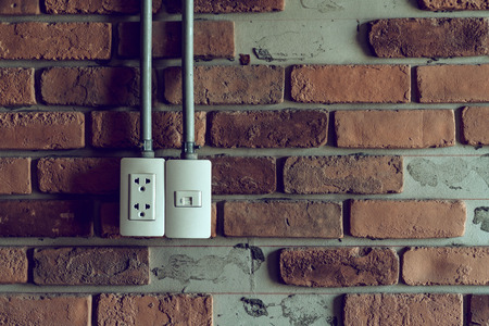 Power plug on brick wall, vintage background with copy spaceの写真素材