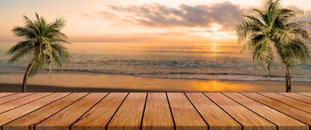 long wooden table with beach landscape blur backgroundの写真素材
