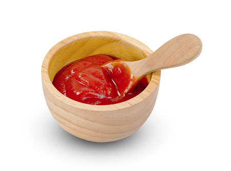 tomato sauce in wooden bowl and spoon isolated on white backgrounの写真素材