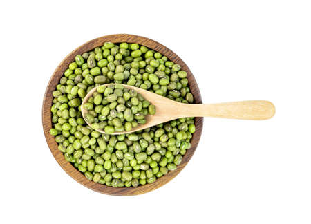 green mung beans with wooden spoon and bowl isolated on white backgroundの写真素材