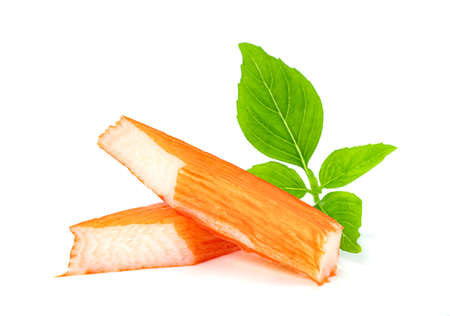 closeup crab sticks with basil leaves isolated on white backgroundの写真素材