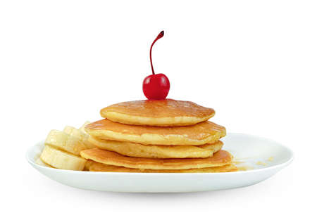 Pancakes with banana sliced and cherry in dish isolated on white