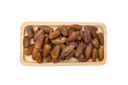 Dry dates palm in wooden bowlの写真素材