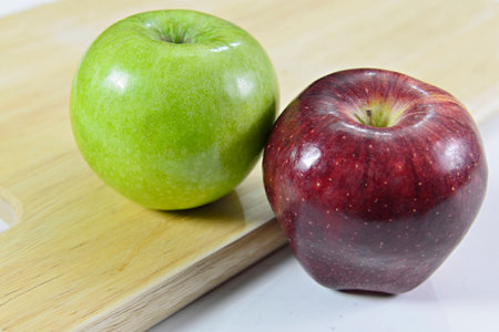 Red apple and green apple on blockの写真素材