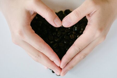 Coffee beans background.Coffee beans in handsの写真素材
