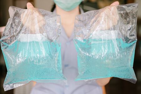 Alcohol gel in the hands Public health officer. Coronavirus prevention medical hand sanitizer gel for hand hygiene corona virus protection.の写真素材