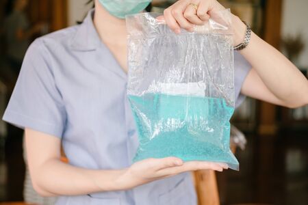 Alcohol gel in the hands Public health officer. Coronavirus prevention medical hand sanitizer gel for hand hygiene corona virus protection.の写真素材