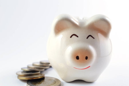 Saving money with piggy bankの写真素材