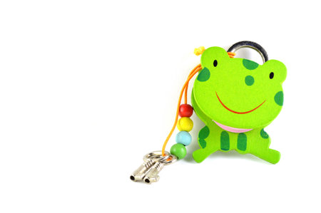 Green frog lock and key isolated on white backgroundの写真素材