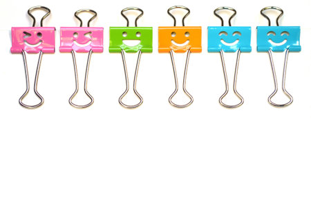 Smiling binder clips on white backgroundの写真素材