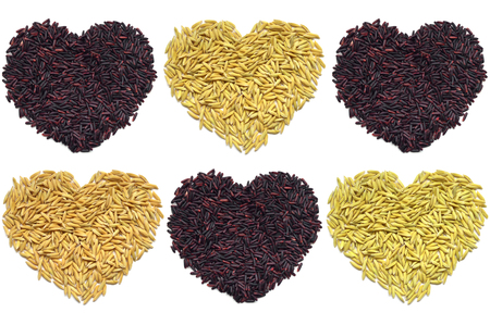 Riceberry and paddy rice heart shape on white background