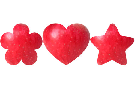 Flower, heart and star shaped halves of apple on white backgroundの写真素材