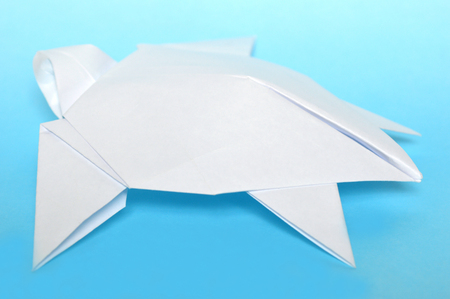 White origami sea turtle on blue backgroundの写真素材