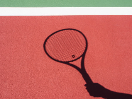 Shadow recquet on tennis courtの写真素材