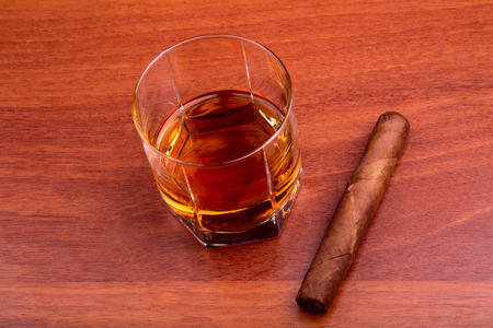 Whiskey and cigar on the wooden tableの写真素材
