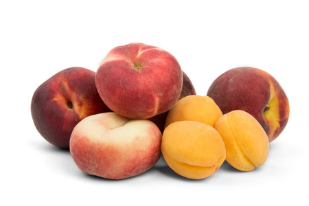 juicy ripe apricots and peaches on a white backgroundの写真素材