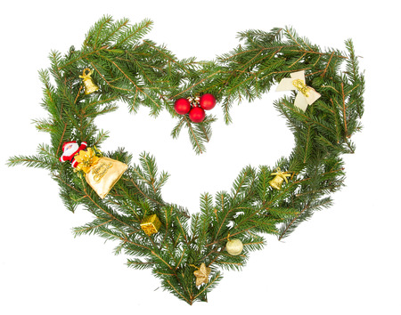 Christmas frame in the shape of a heart with yellow decorationsの写真素材