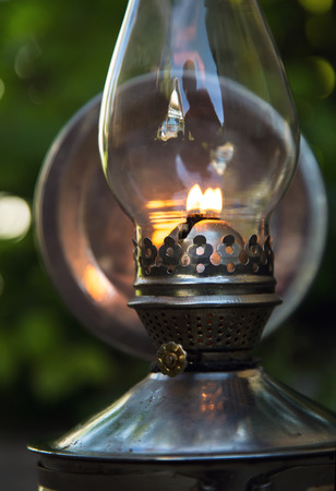 old kerosene lamp stands on the ground, outdoorsの写真素材