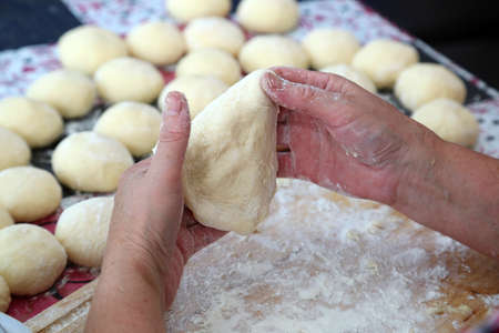 grandma cooks pies from fluffy dough for grandchildren