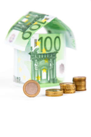 houses made of euro bills, isolated on a white backgroundの写真素材