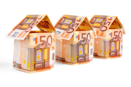 houses made of euro bills, isolated on a white backgroundの写真素材