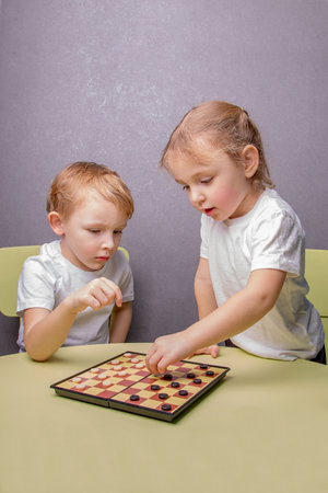Small children play chessの写真素材