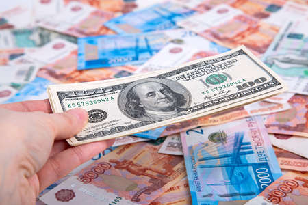 Wooden house and keys in Russian rubles on a white backgroundの写真素材