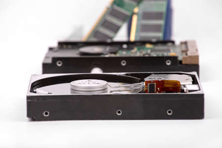 Disassembled hard drive against the background of the drive and RAM modulesの写真素材