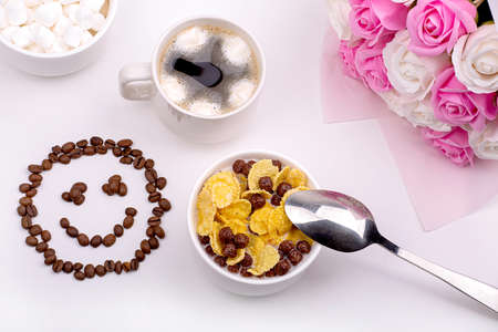 good breakfast. Cereal with milk, coffee with marshmallows, a bouquet of roses and a smiling smile...