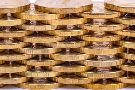 money background. Stacks of gold coins in staggered order, close-upの写真素材