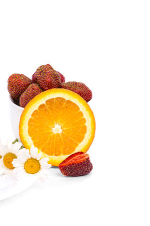 Juicy piece of orange and ripe strawberries on a white background close-upの写真素材