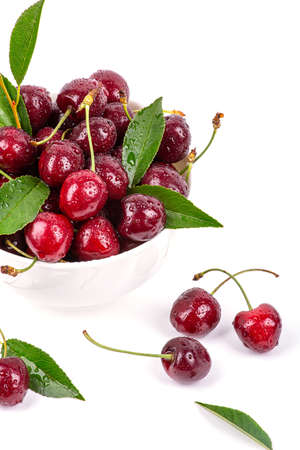 Ripe cherry in drops of water, isolated on a white background, close-upの写真素材
