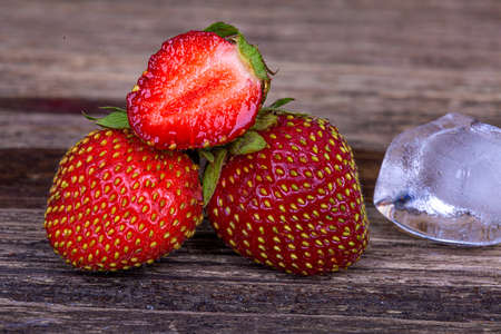 Ripe strawberries on a wooden background, macro photographyの写真素材