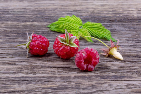 Ripe raspberries close-up, on an old wooden background, macro photographyの写真素材