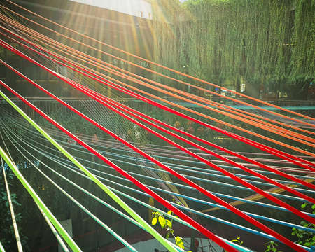 Multi-colored strings stretching over the playground