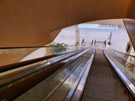 Wide angle shot of an enormous escalator, going down