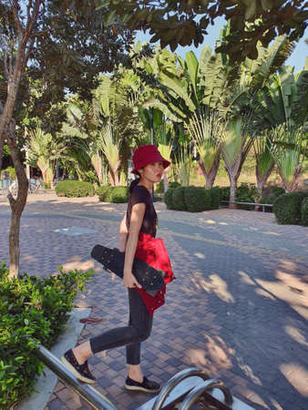 A woman going out for skateboarding in matching red outfitの写真素材