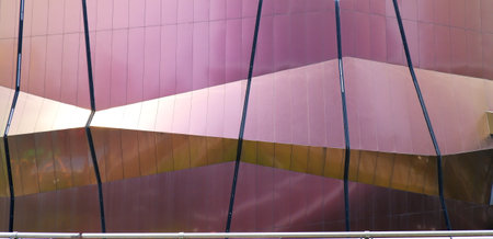 Purple metallic exterior of a huge building in the middle of the cityの写真素材