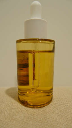Front view of a golden glass ampoule bottle, full frameの写真素材