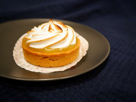 Lemon meringue tart on the right with a copy spaceの写真素材