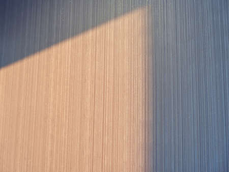 Sunlight casting shadow and light on sparkling wallの写真素材