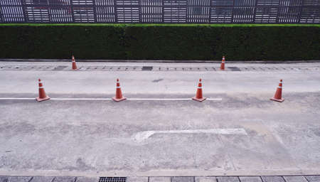 Red traffic cones arrangement on cement roadの写真素材