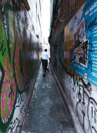 Bangkok, Thailand-04.15.21: Local man pushing his cart through a narrow alley back to his homeのeditorial素材