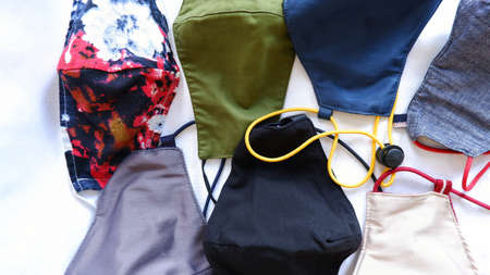 Several colorful masks lined on bedsheetの写真素材