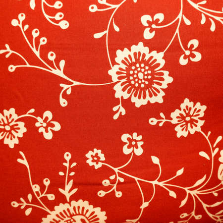 Red fabric with flower patterns closed upの写真素材