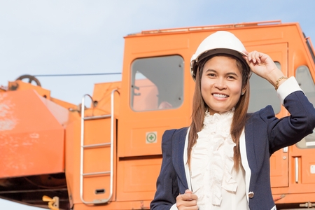 Beautiful young woman engineer wearing a helmet.の写真素材