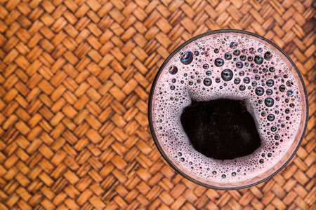 Glass of red wine on the mat,The Top View.